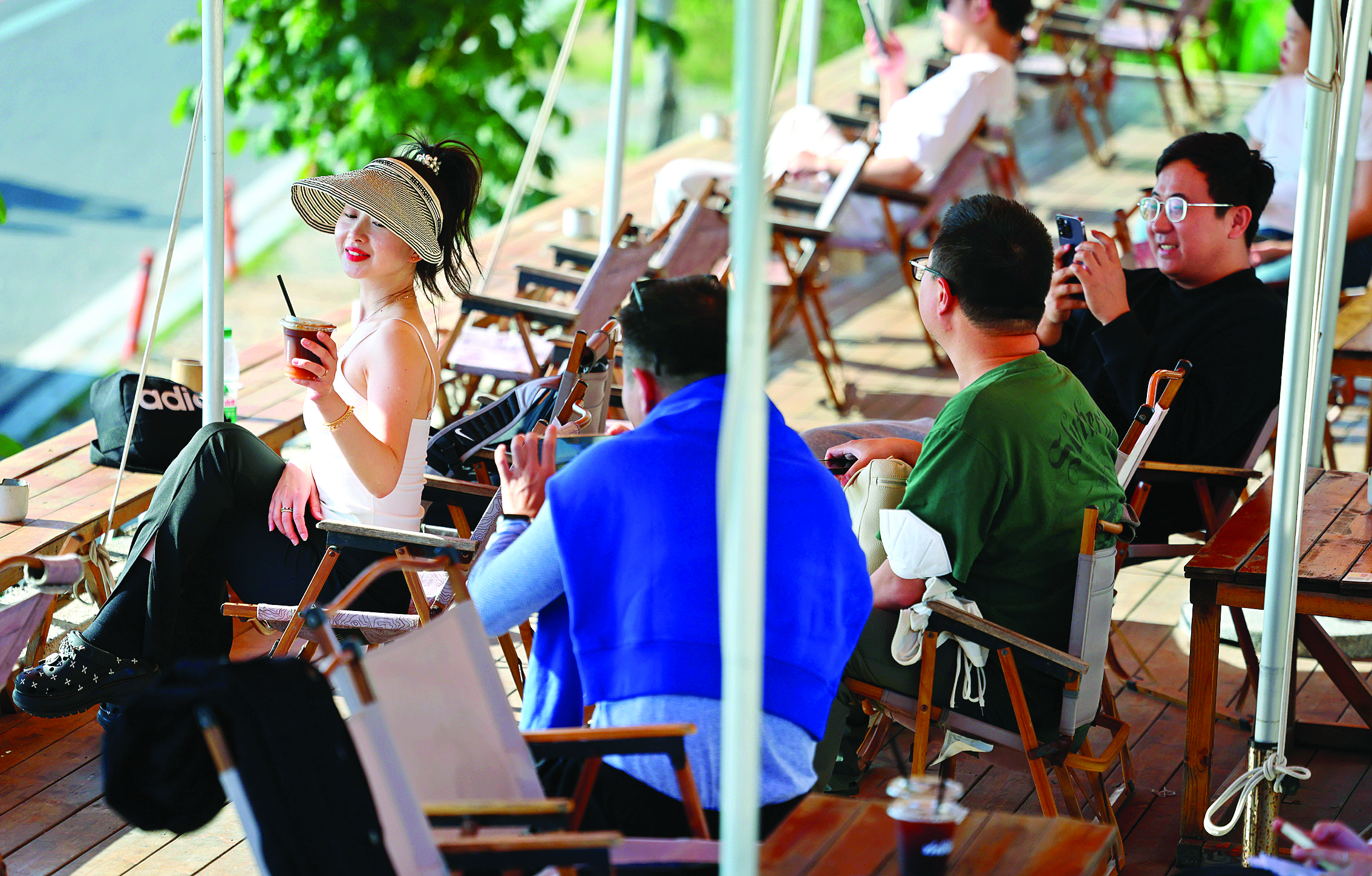     游客在汕尾市水龟寮村海岸线边的一家咖啡馆里喝咖啡。新华社发