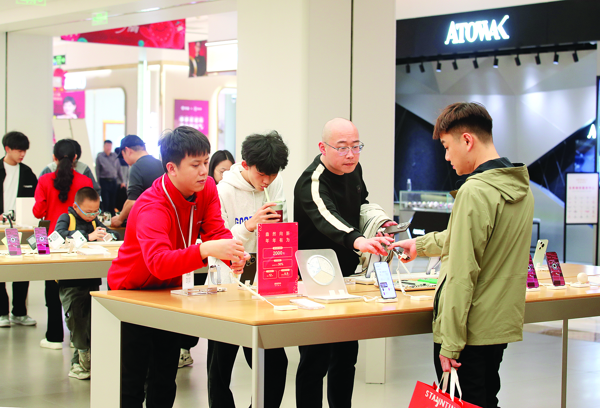     2月1日，市民在商场选购手机。惠州日报记者钟畅新 摄