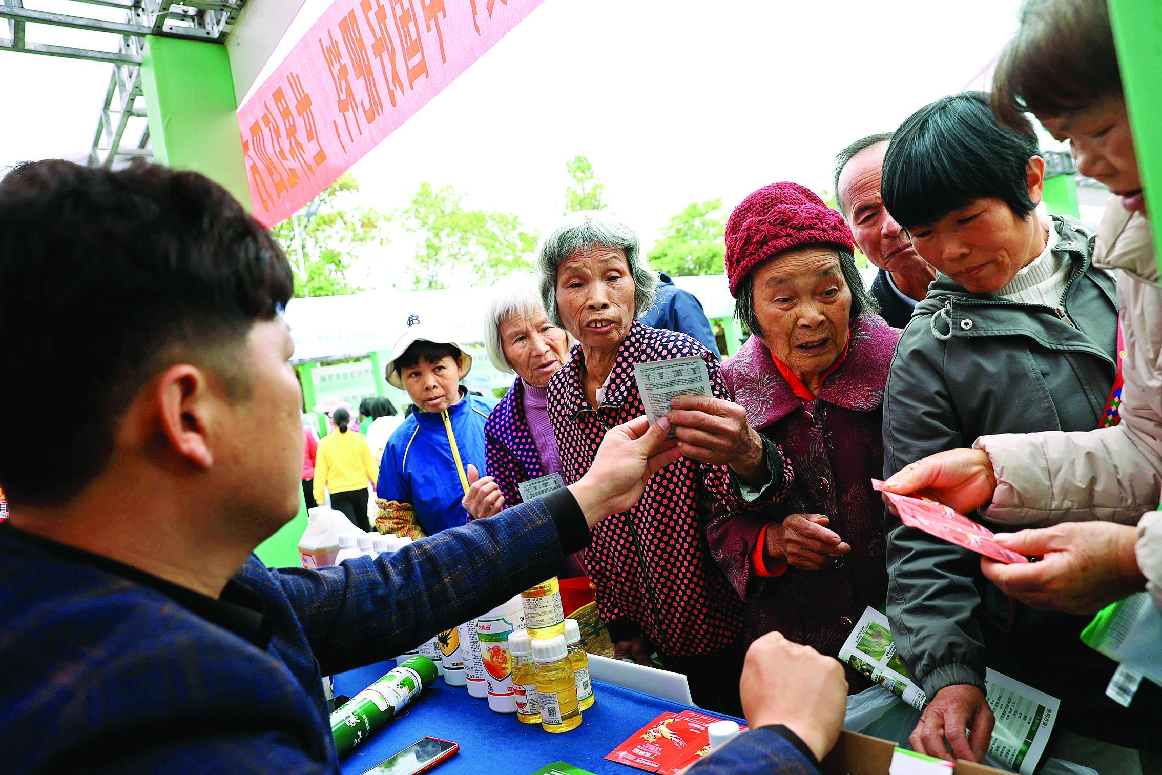     惠州市春耕现场会在博罗县麻陂镇洪湖村举行，村民在领取农药。