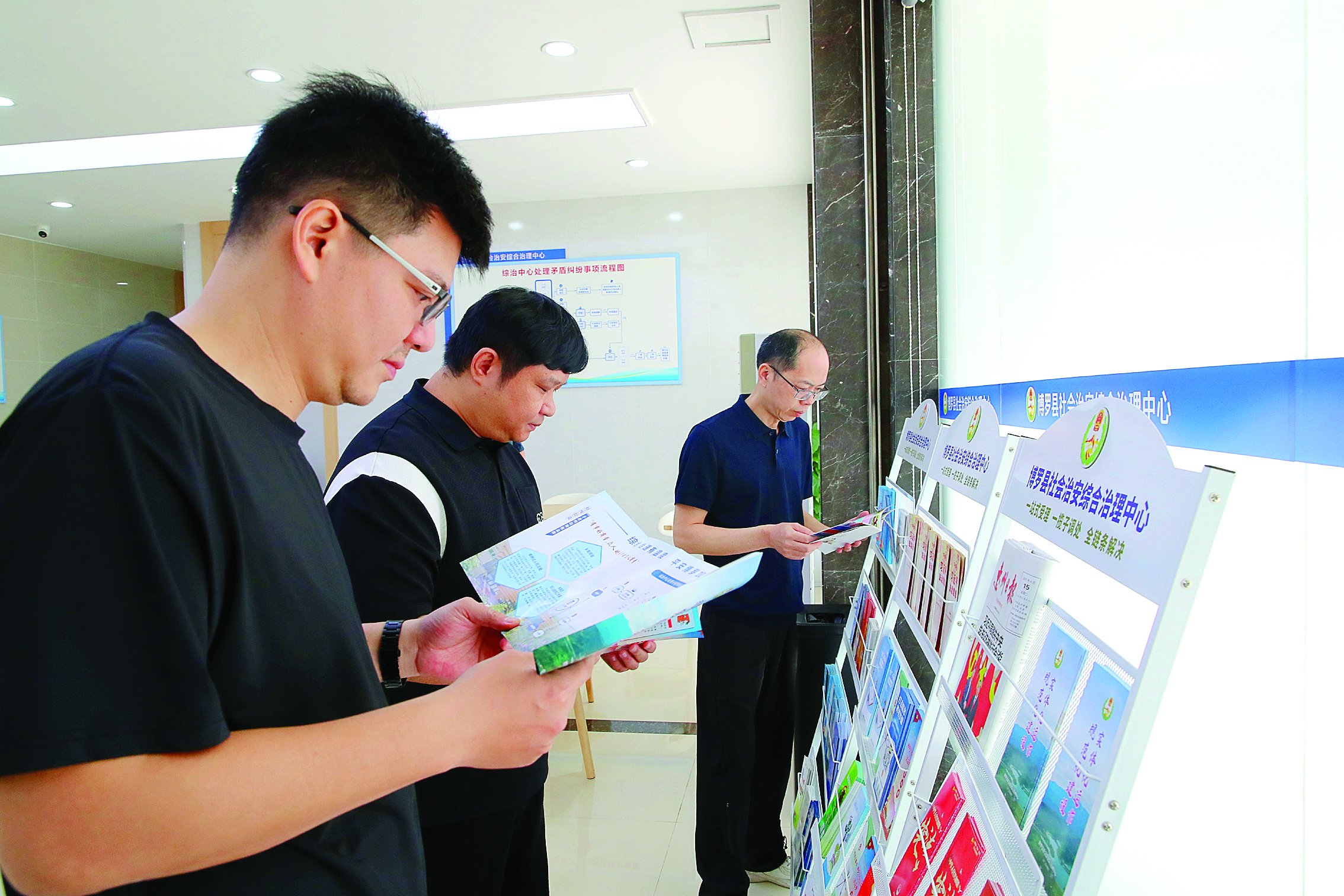     市民在博罗县综治中心阅读有关读本。