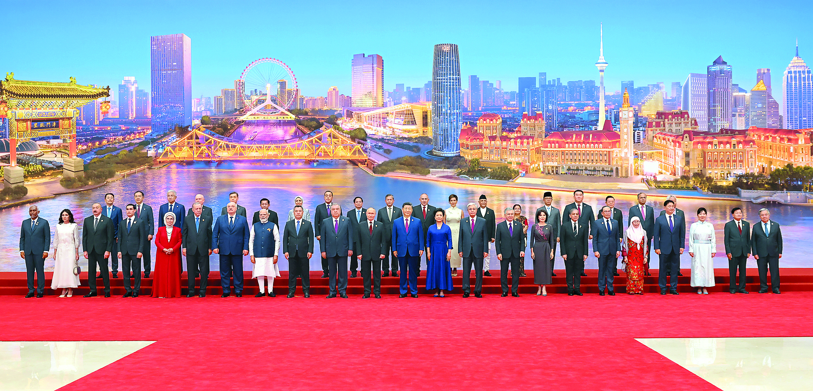     8月31日晚，国家主席习近平和夫人彭丽媛在天津梅江会展中心举行宴会，欢迎来华出席2025年上海合作组织峰会的国际贵宾。这是宴会前，习近平和彭丽媛同贵宾们集体合影留念。新华社发