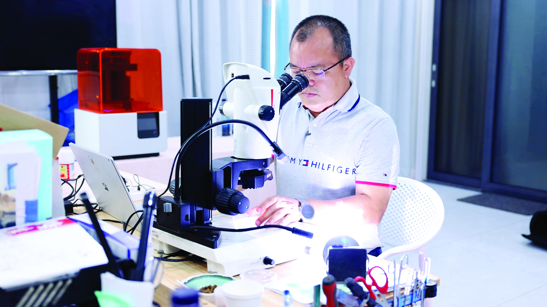     颜阔秋通过显微镜观察受精卵。