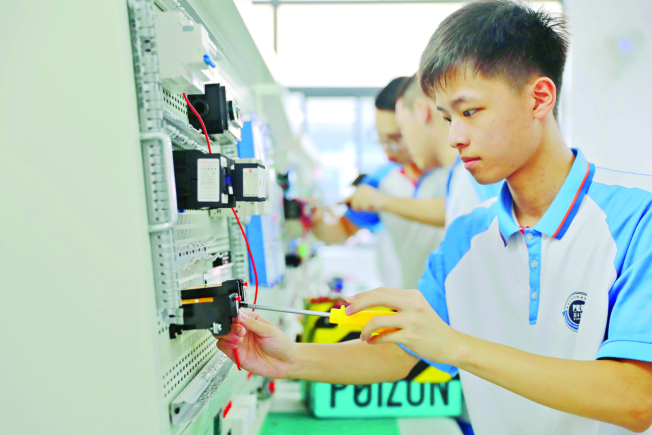     学生聚精会神地参加校内技能比赛。