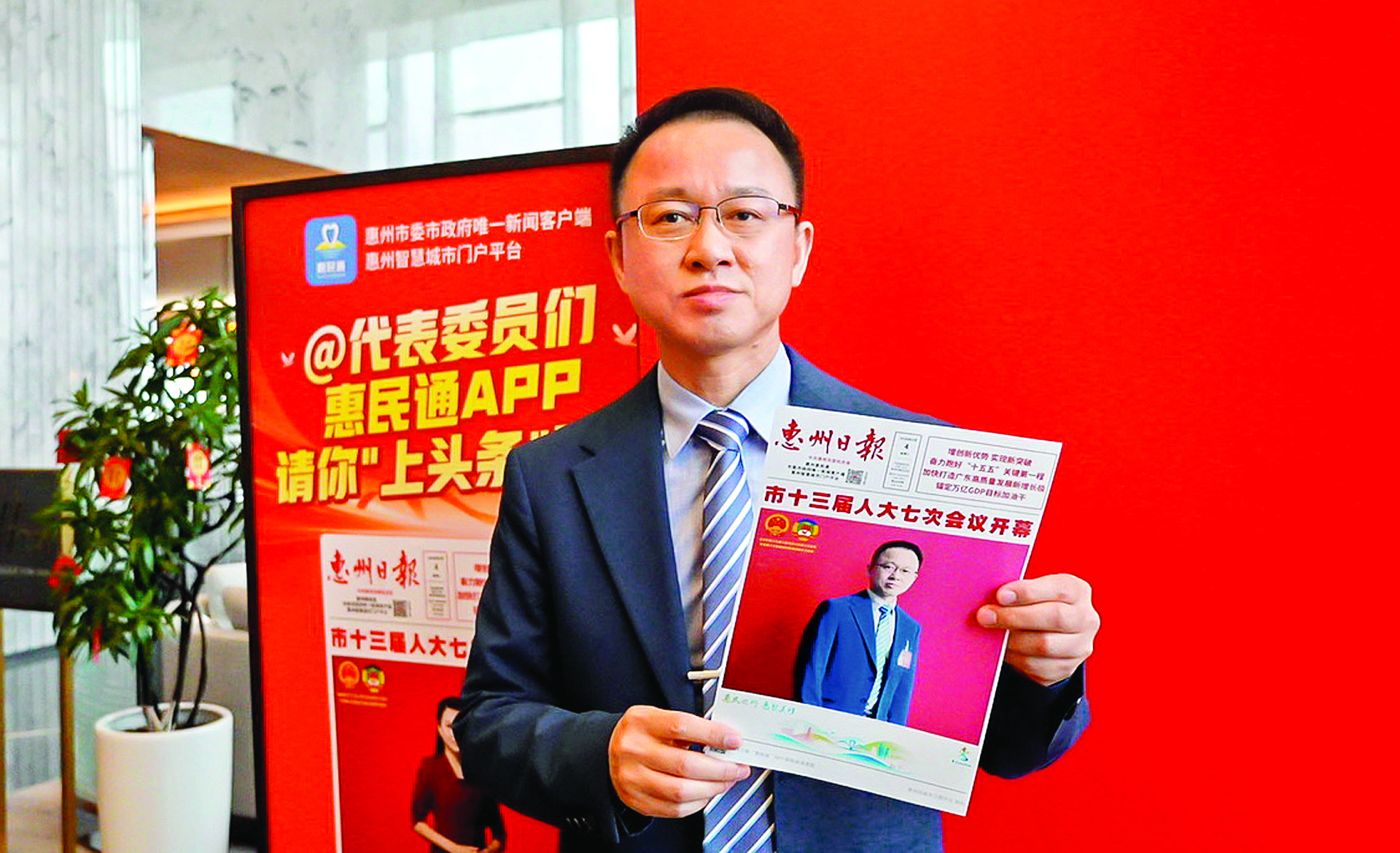     人大代表在展示自己上“头条”的照片。惠州日报记者李苗 摄